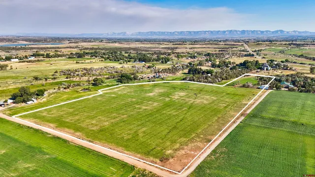 a view of a field with an ocean view