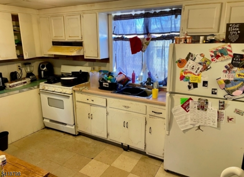 150 Atlanta Avenue Union, NJ 07088 - Photo 11 of 26 a kitchen with stainless steel appliances a stove a microwave and cabinets