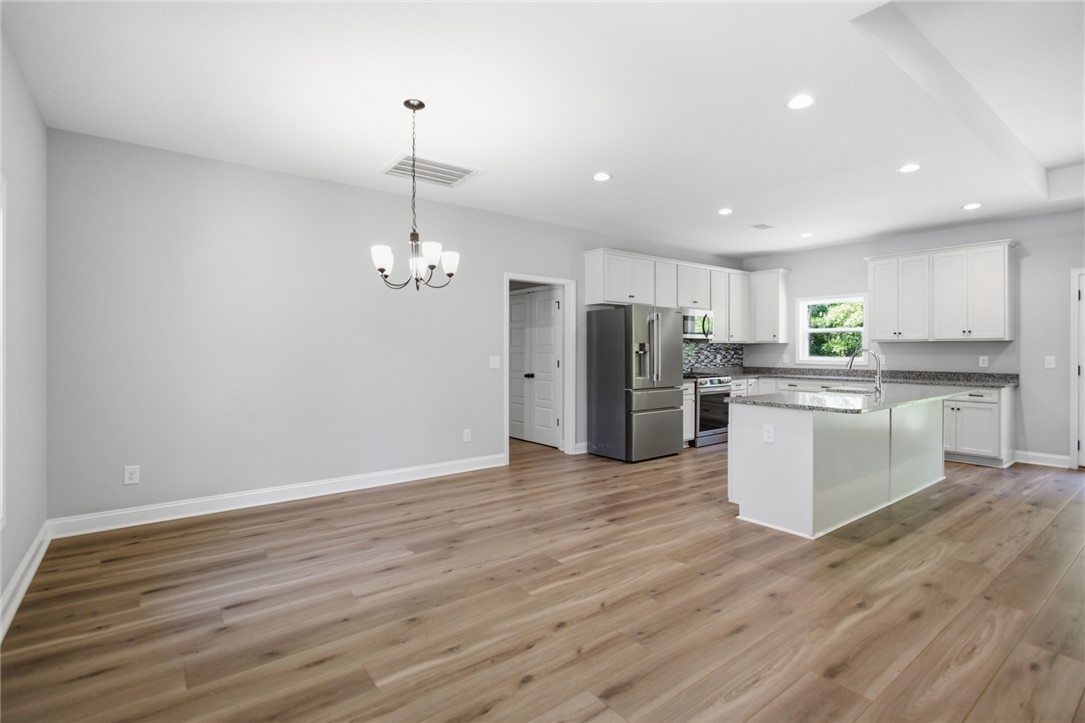 912 Watercrest Road West Union, SC 29696 - Photo 13 of 49 This open concept space features a kitchen island and durable flooring, ideal for everyday living.