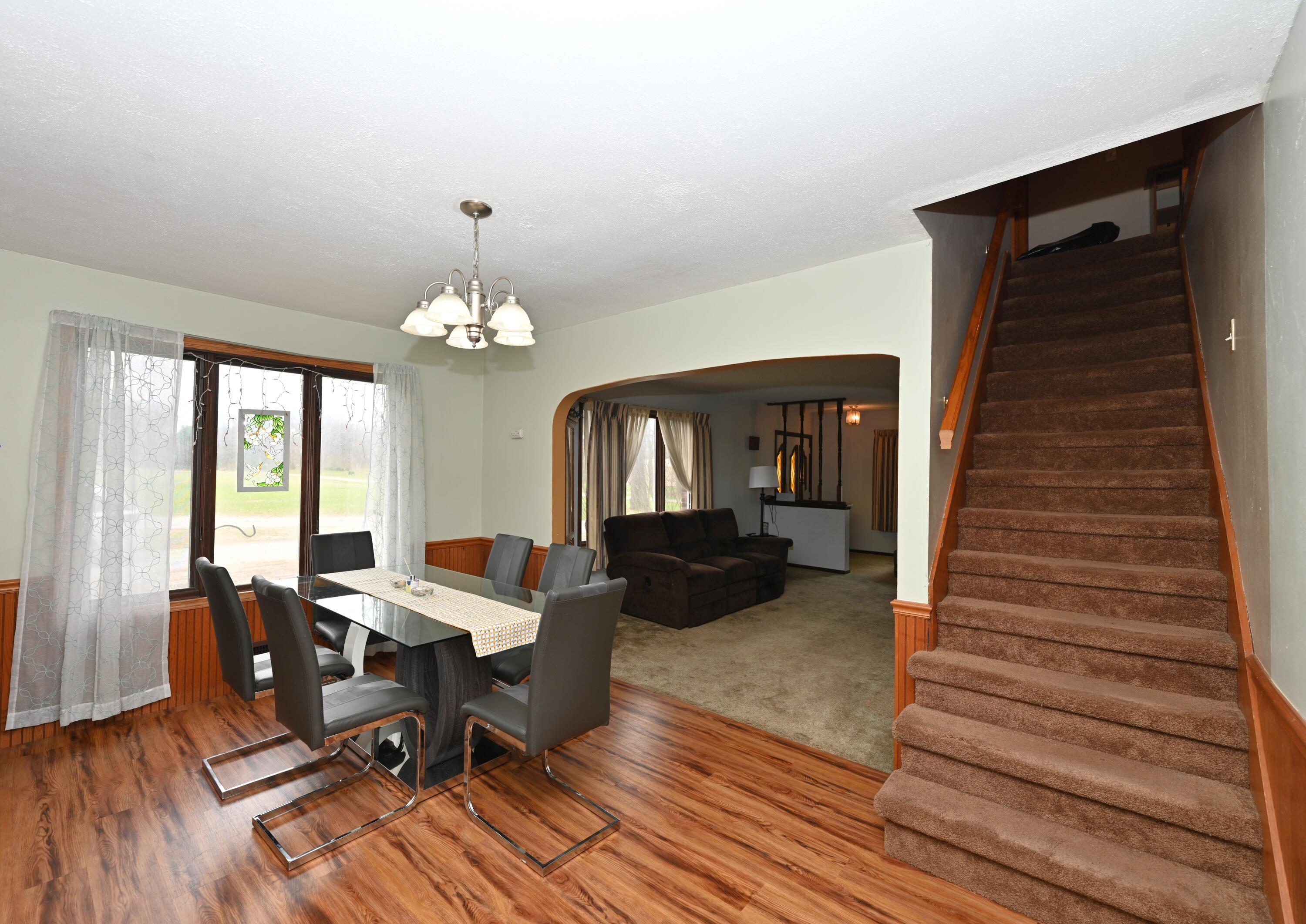 5110 West 400 North Winamac, IN 46996 - Photo 15 of 35 a living room with furniture a chandelier and a wooden floor
