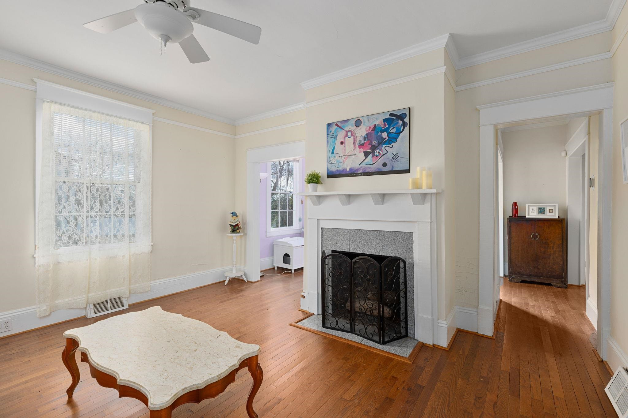 330 Pershing Road Raleigh, NC 27608 - Photo 4 of 51 Upon entry, you will be greeted by these beautiful hardwoods and the first of 2 fireplaces in this home. Please note, the black fireplace screen will not convey. Living Room W/Fireplace