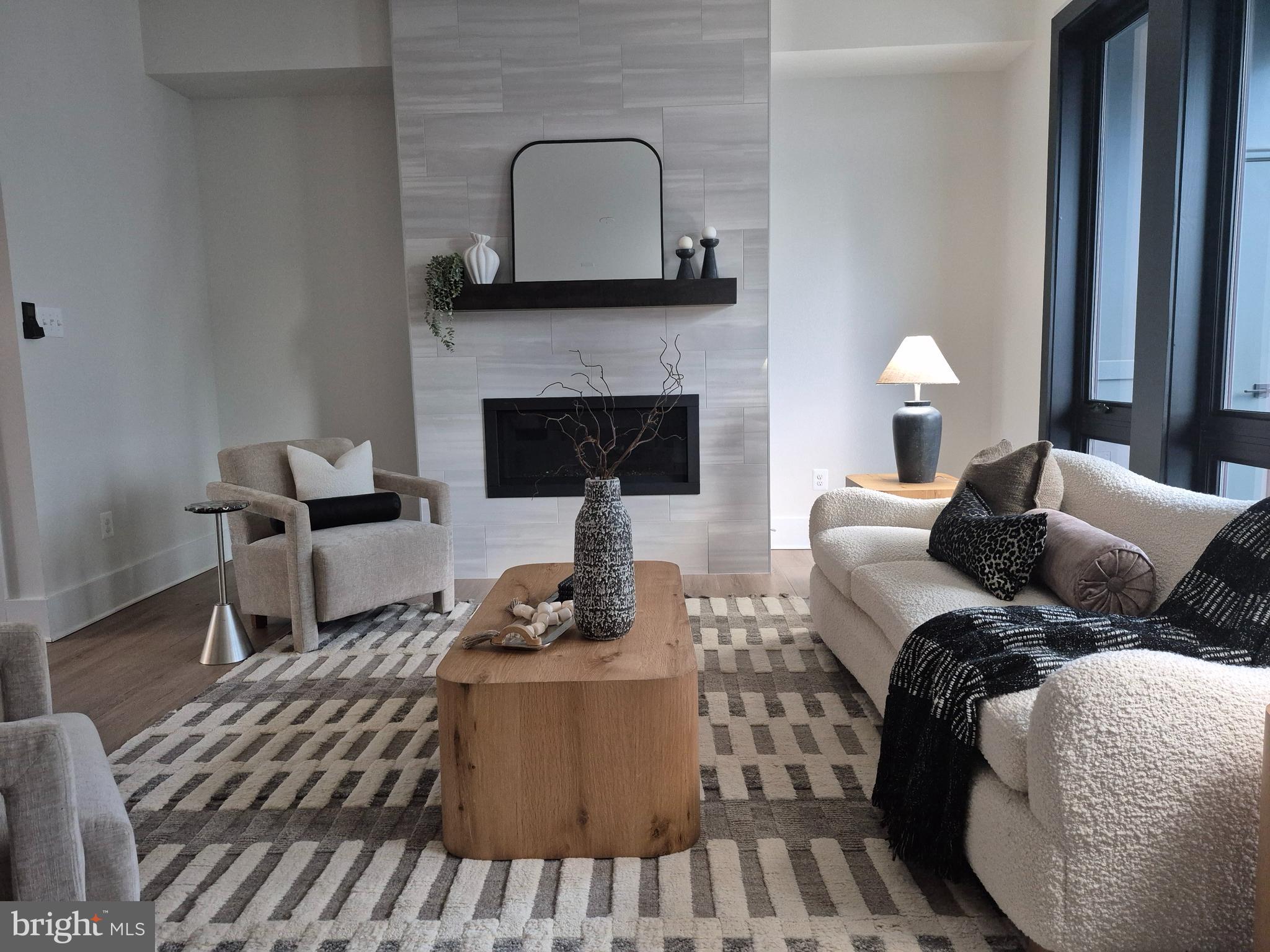 14944 Dispatch Street, Unit 2 Rockville, MD 20850 - Photo 12 of 36 a living room with furniture and a fireplace