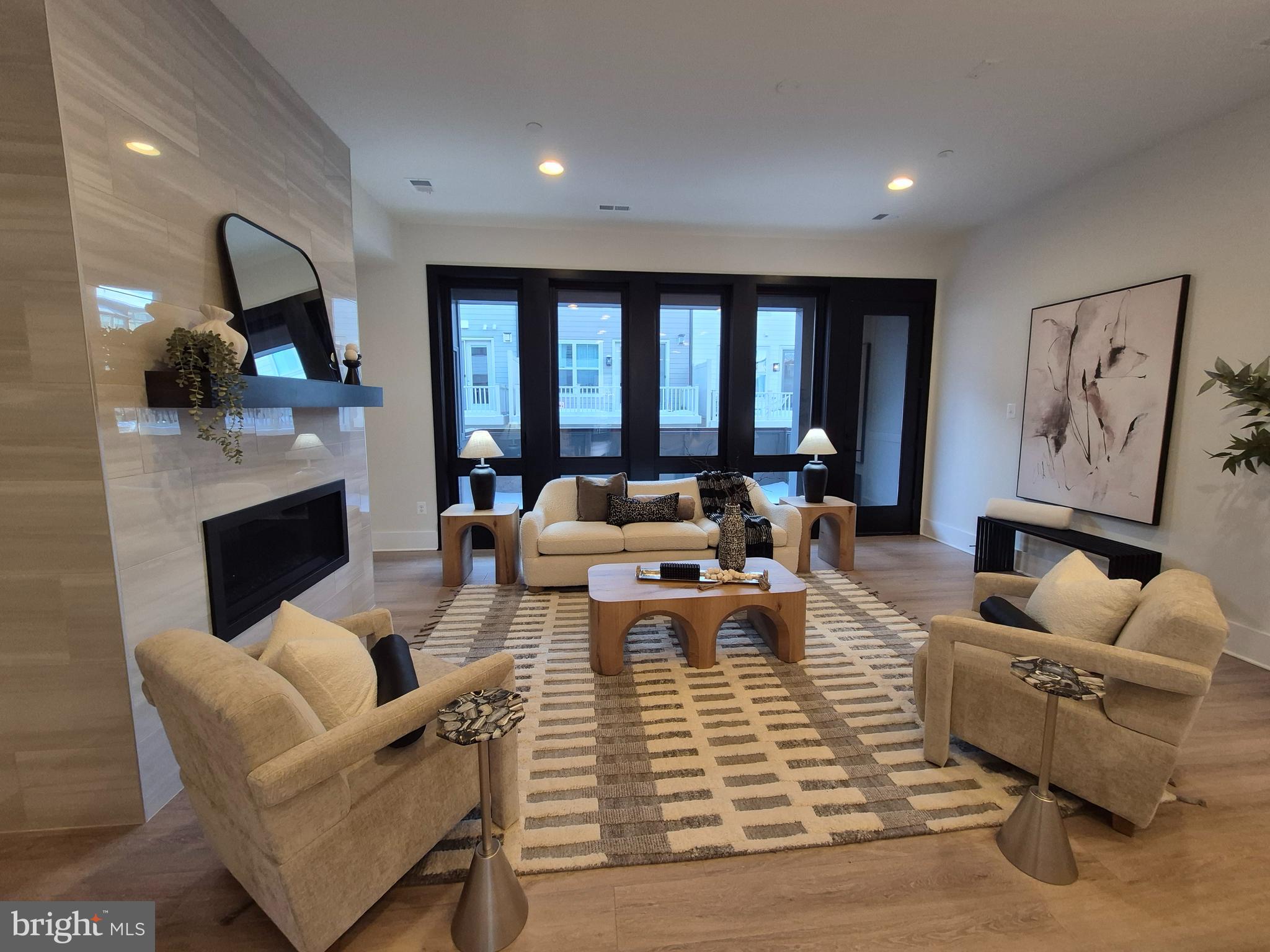 14944 Dispatch Street, Unit 2 Rockville, MD 20850 - Photo 13 of 36 a living room with fireplace furniture and a large window