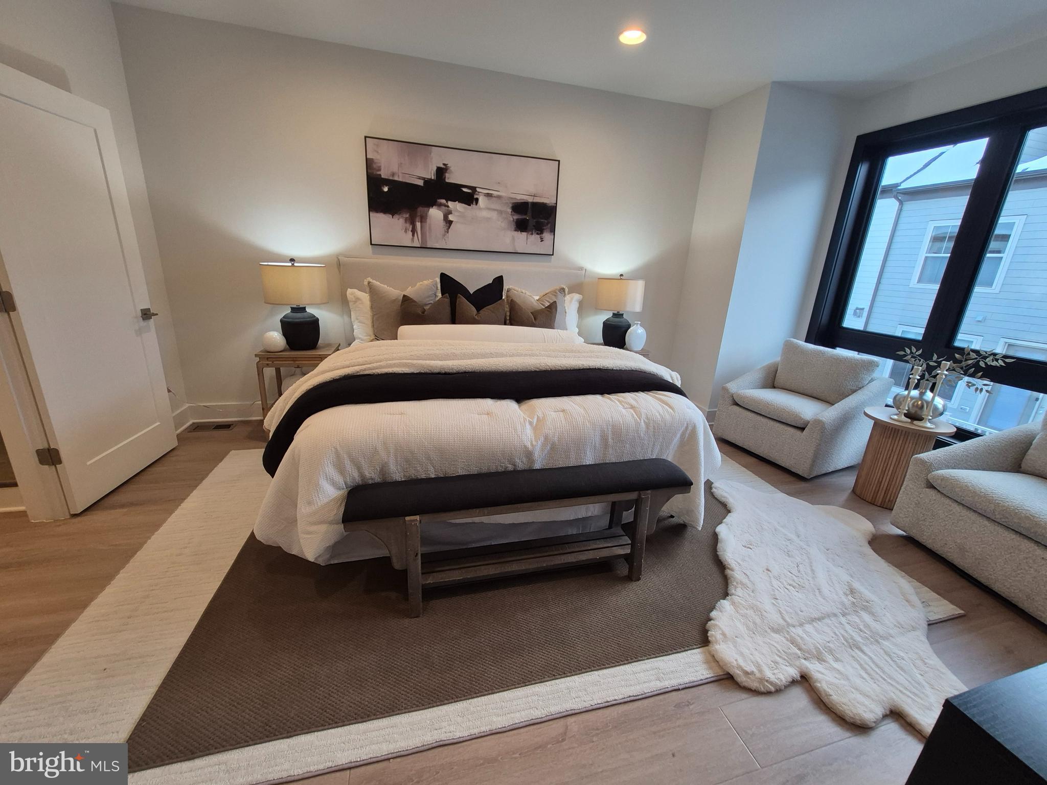 14944 Dispatch Street, Unit 2 Rockville, MD 20850 - Photo 19 of 36 a bedroom with a bed couch and a window