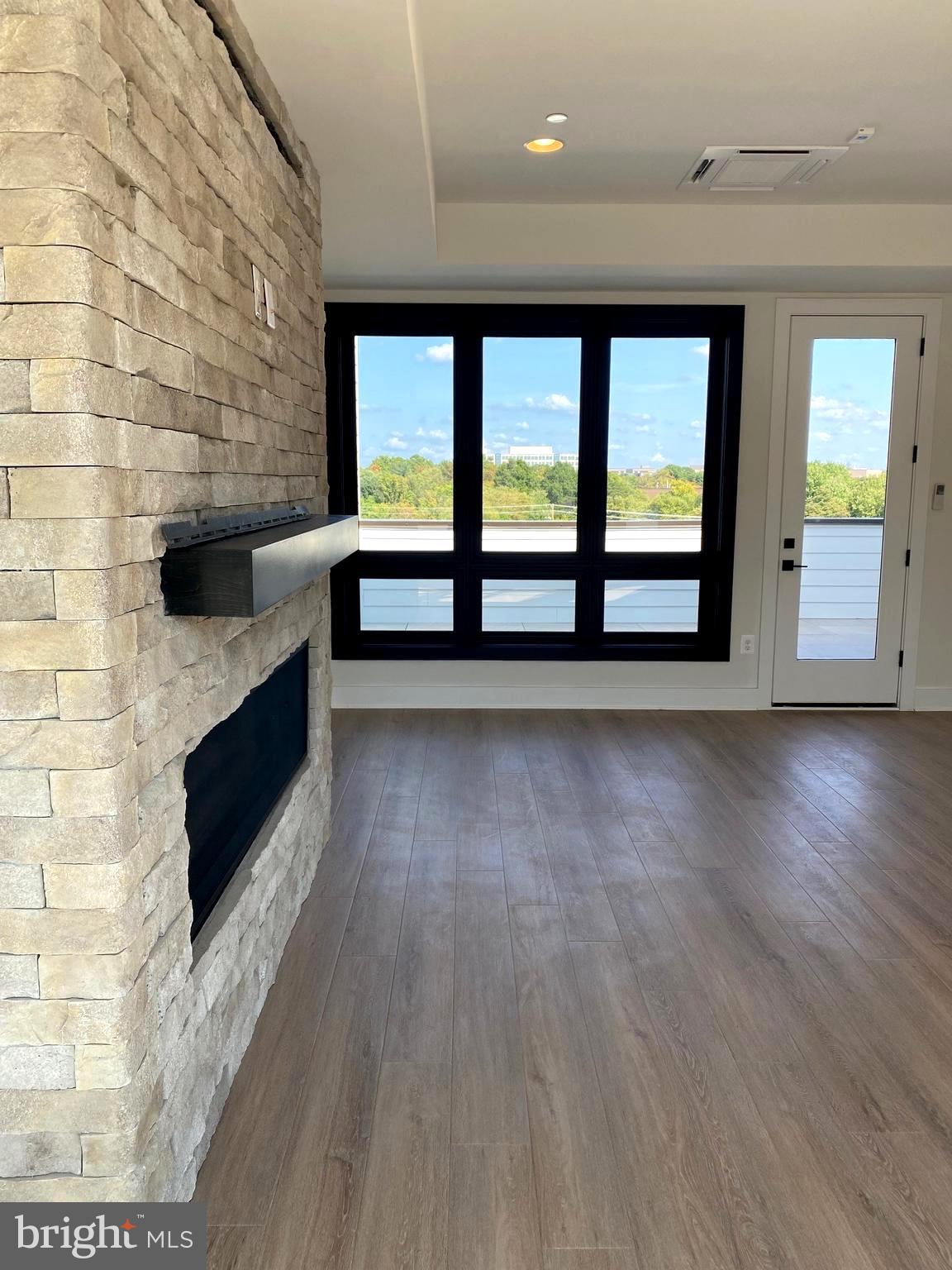 14944 Dispatch Street, Unit 2 Rockville, MD 20850 - Photo 29 of 36 a view of an empty room with glass door and a window