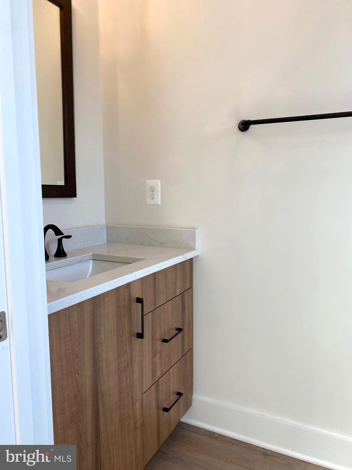 14944 Dispatch Street, Unit 2 Rockville, MD 20850 - Photo 30 of 36 a bathroom with a sink and a mirror