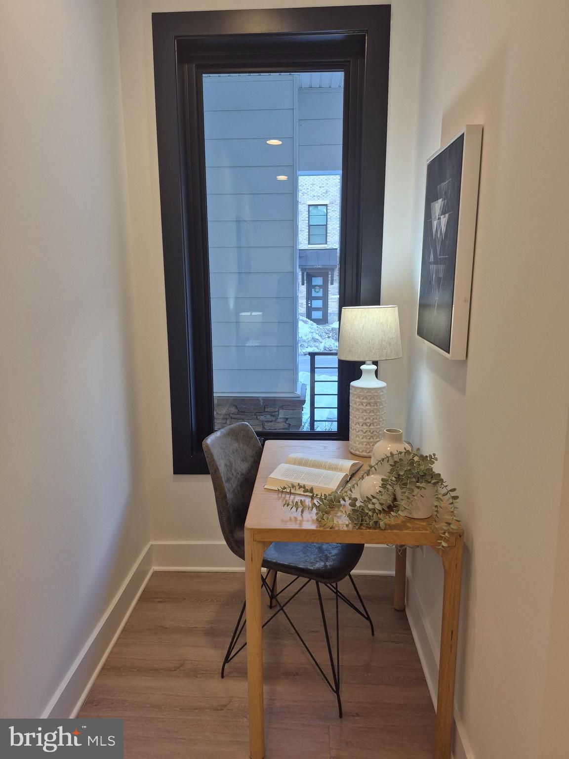 14944 Dispatch Street, Unit 2 Rockville, MD 20850 - Photo 4 of 36 a view of a hallway that has a table and chairs
