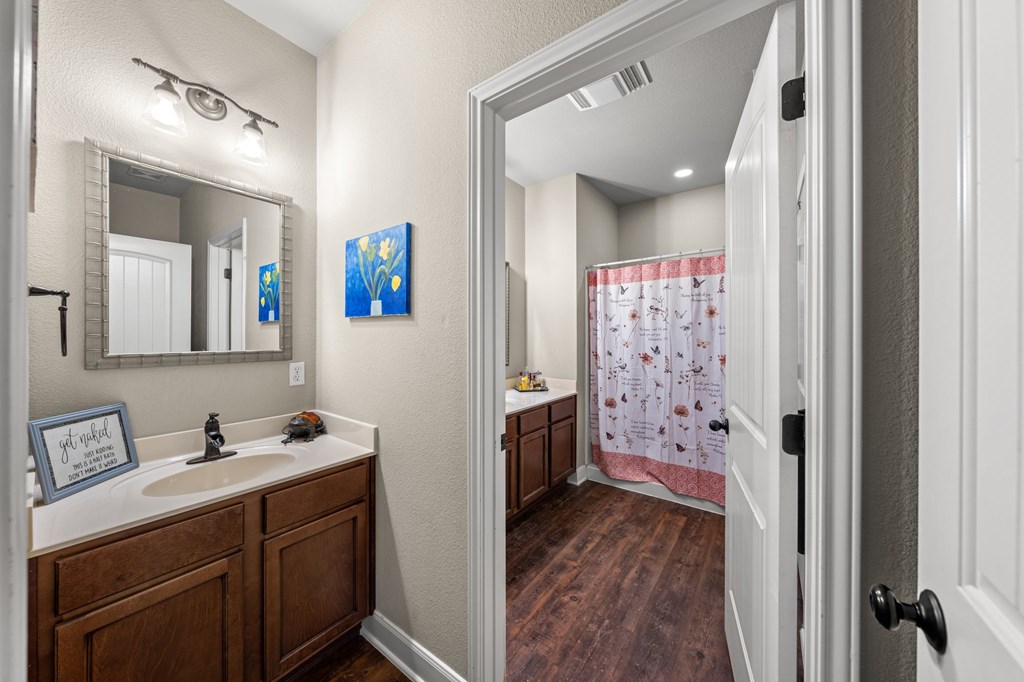 116 Jasper Lane North Kerrville, TX 78028 - Photo 12 of 27 a bathroom with a sink a mirror and a shower