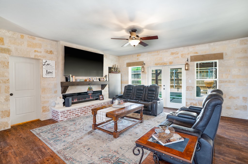 116 Jasper Lane North Kerrville, TX 78028 - Photo 3 of 27 a living room with furniture a flat screen tv and a fireplace