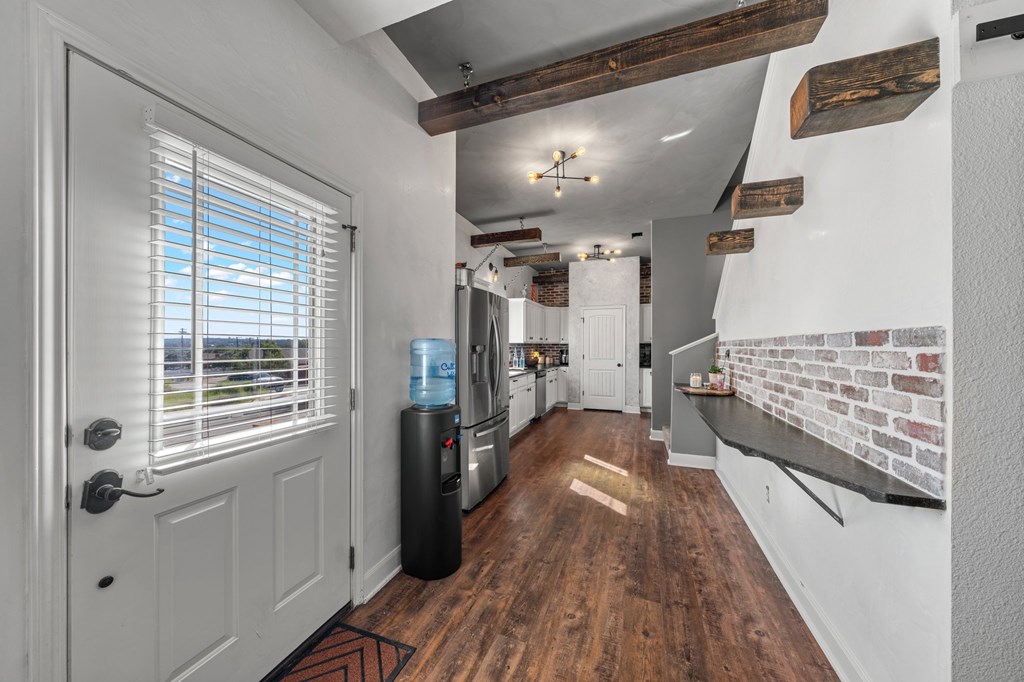 116 Jasper Lane North Kerrville, TX 78028 - Photo 7 of 27 a view of a hallway with wooden floor and staircase