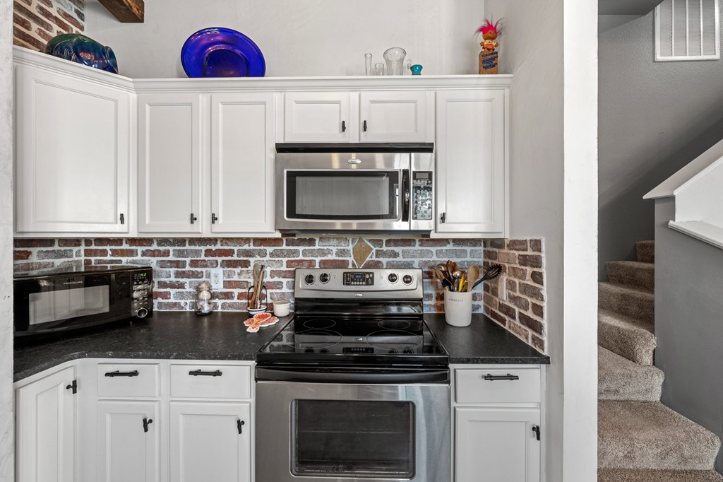 116 Jasper Lane North Kerrville, TX 78028 - Photo 9 of 27 a kitchen with white cabinets and appliances