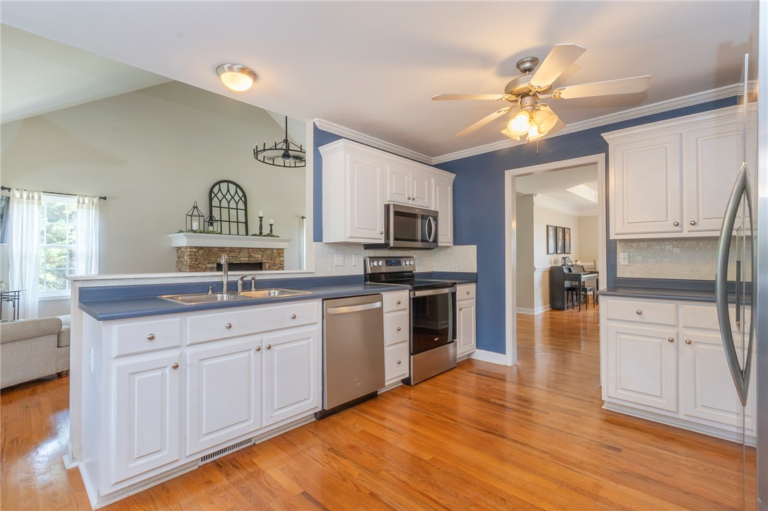 861 North Old Pendleton Road Liberty, SC 29657 - Photo 11 of 45 A well-appointed kitchen features warm hardwood floors and a convenient pass-through to the living area.