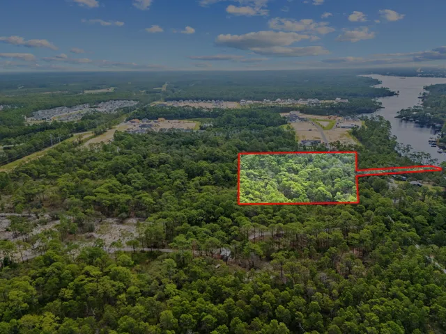 a view of a pathway both side of grassy field with shrub