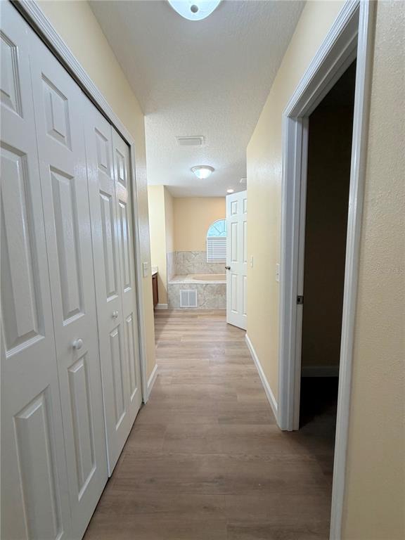 413 Britten Drive Kissimmee, FL 34758 - Photo 12 of 20 a view of a hallway with wooden floor