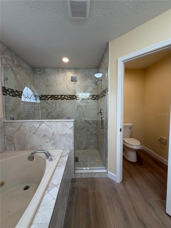 413 Britten Drive Kissimmee, FL 34758 - Photo 15 of 20 a bathroom with a tub a toilet and a shower