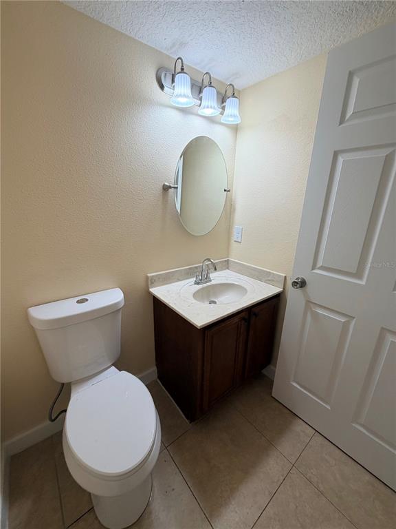 413 Britten Drive Kissimmee, FL 34758 - Photo 18 of 20 a bathroom with a toilet sink and mirror