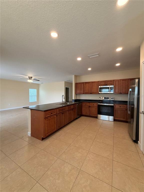 413 Britten Drive Kissimmee, FL 34758 - Photo 5 of 20 a large kitchen with a large counter top and appliances