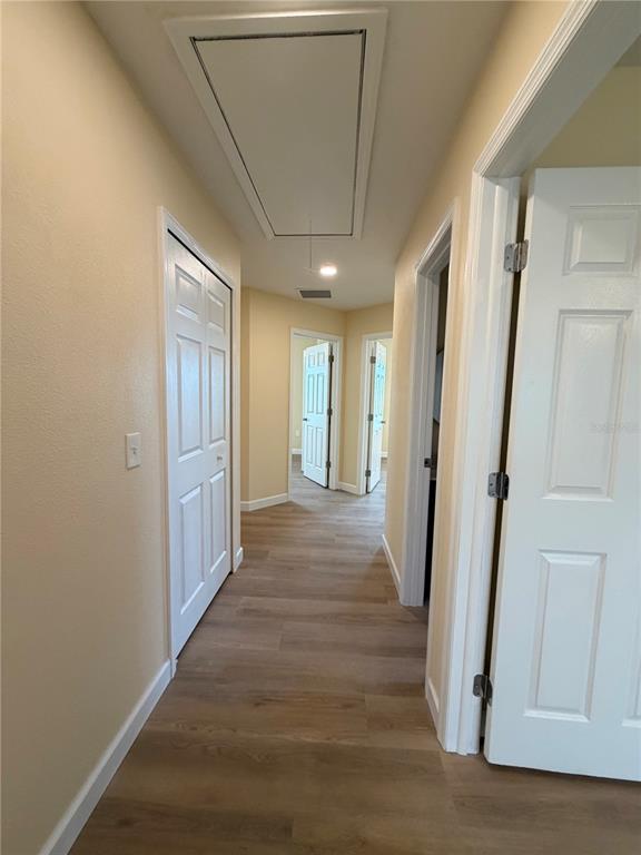 413 Britten Drive Kissimmee, FL 34758 - Photo 7 of 20 a view of a hallway with wooden floor and staircase