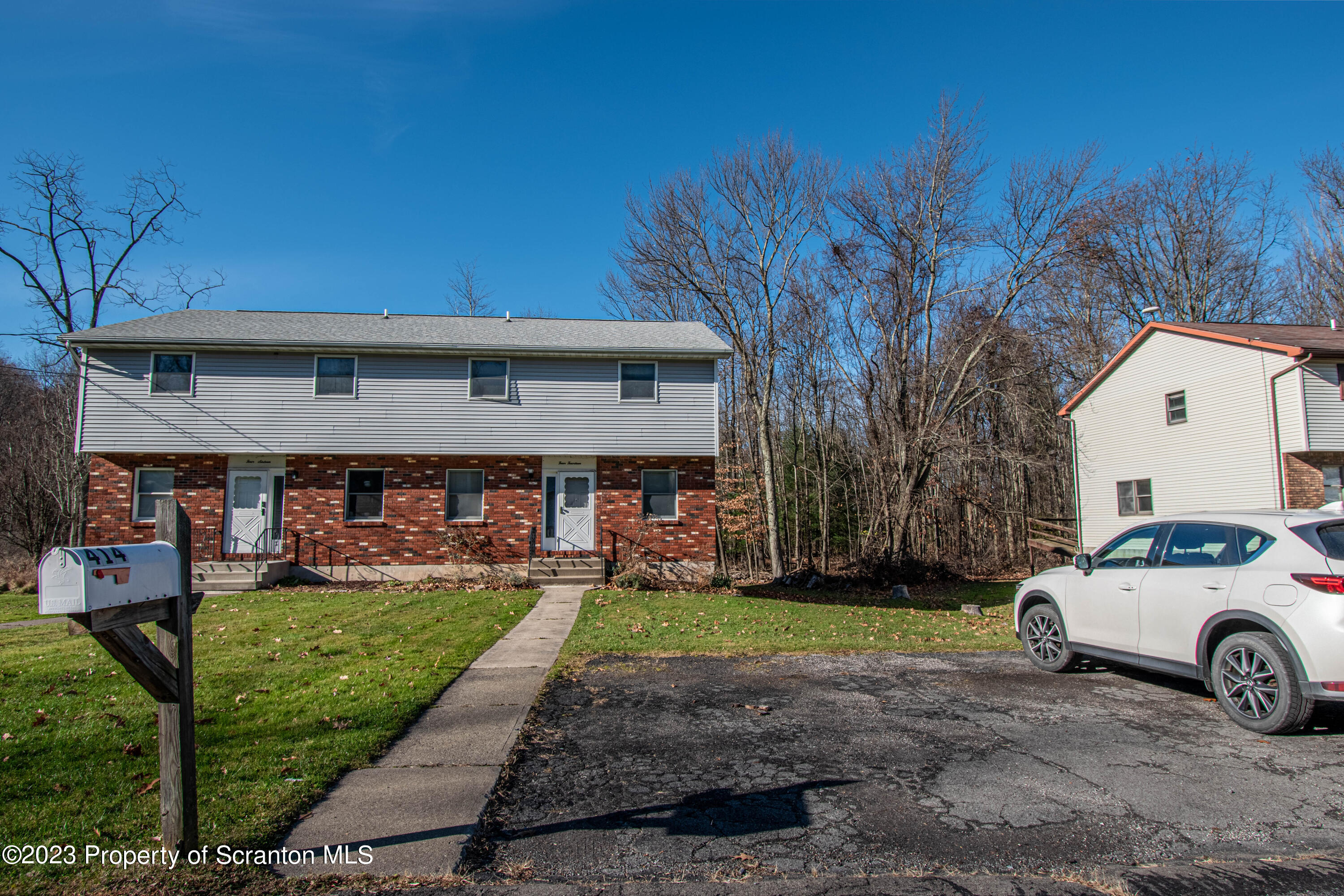 414 Melrose Avenue Clarks Summit, PA 18411 - Photo 1 of 29 a front view of a house with garden
