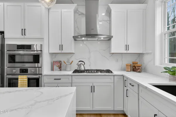 a kitchen with stainless steel appliances granite countertop a sink and cabinets