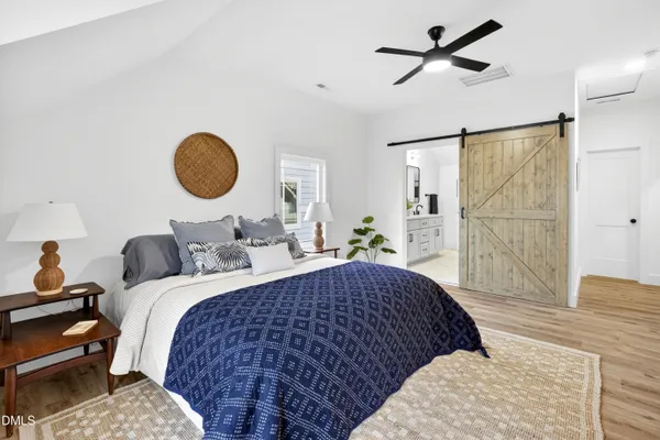 a bedroom with bed and wooden floor