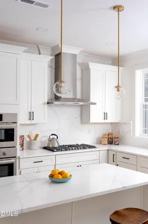 a kitchen with a sink a stove and cabinets