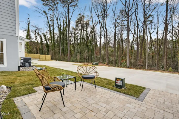 a balcony with wooden floor and outdoor seating