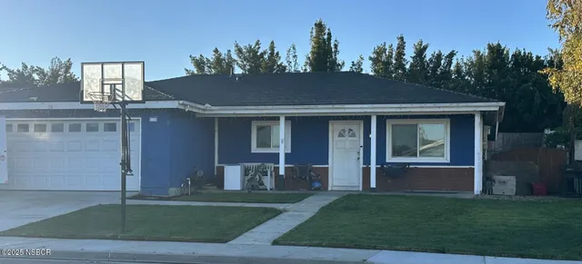 a view of a house with a yard and a garden