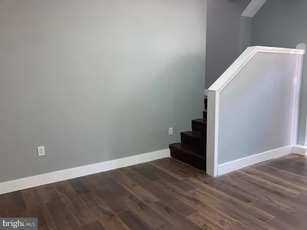 a view of a hallway with wooden floor and entryway