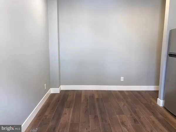 a view of a room with wooden floor