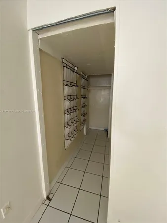 a view of an empty room and a window