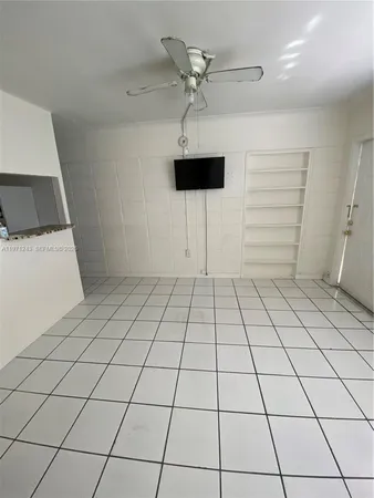 a kitchen with a stove sink and cabinets