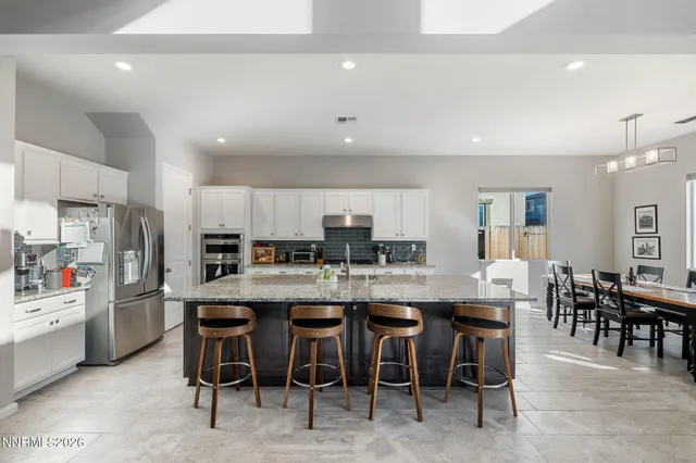 a large kitchen with a table and chairs