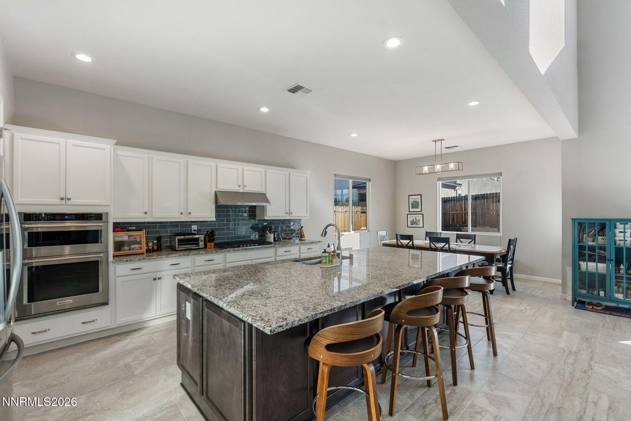 2370 Buttermere Drive Reno, NV 89521 - Photo 14 of 37 a kitchen with granite countertop a stove and chairs