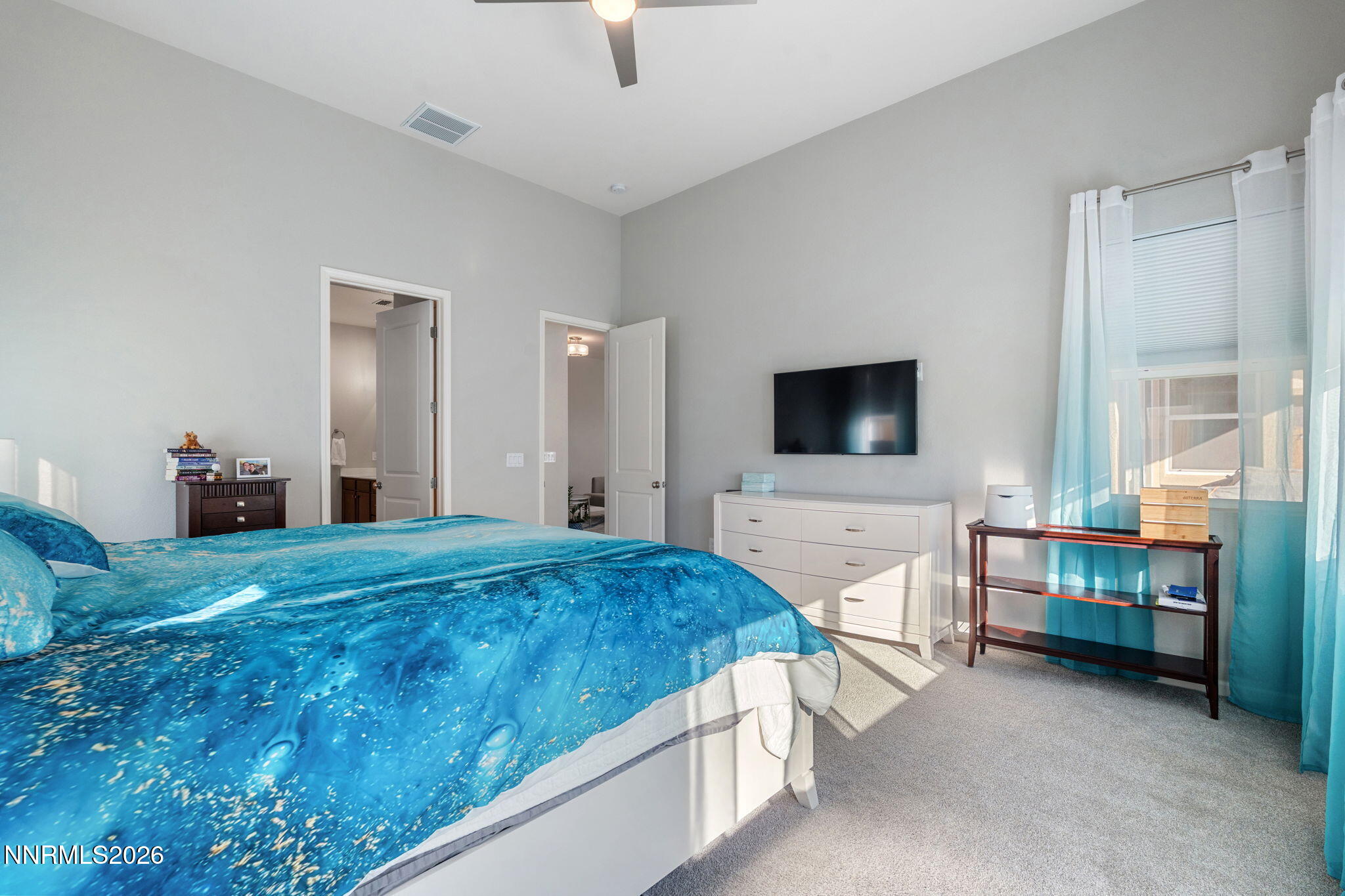 2370 Buttermere Drive Reno, NV 89521 - Photo 19 of 37 a spacious bedroom with a bed and a flat screen tv