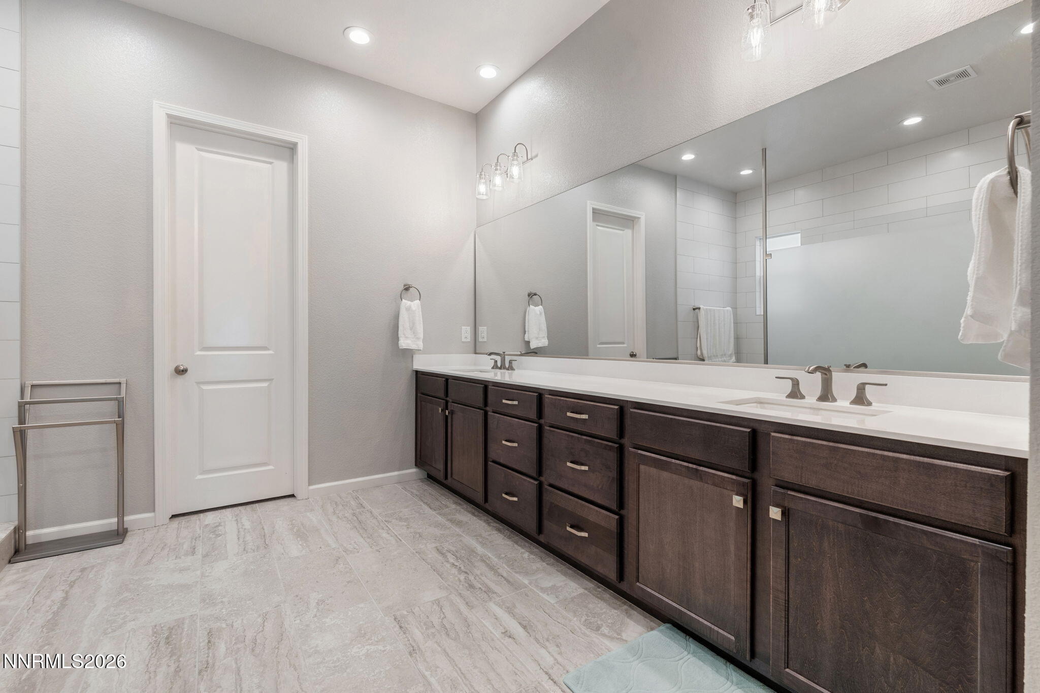 2370 Buttermere Drive Reno, NV 89521 - Photo 20 of 37 a bathroom with double vanity sinks and a mirror