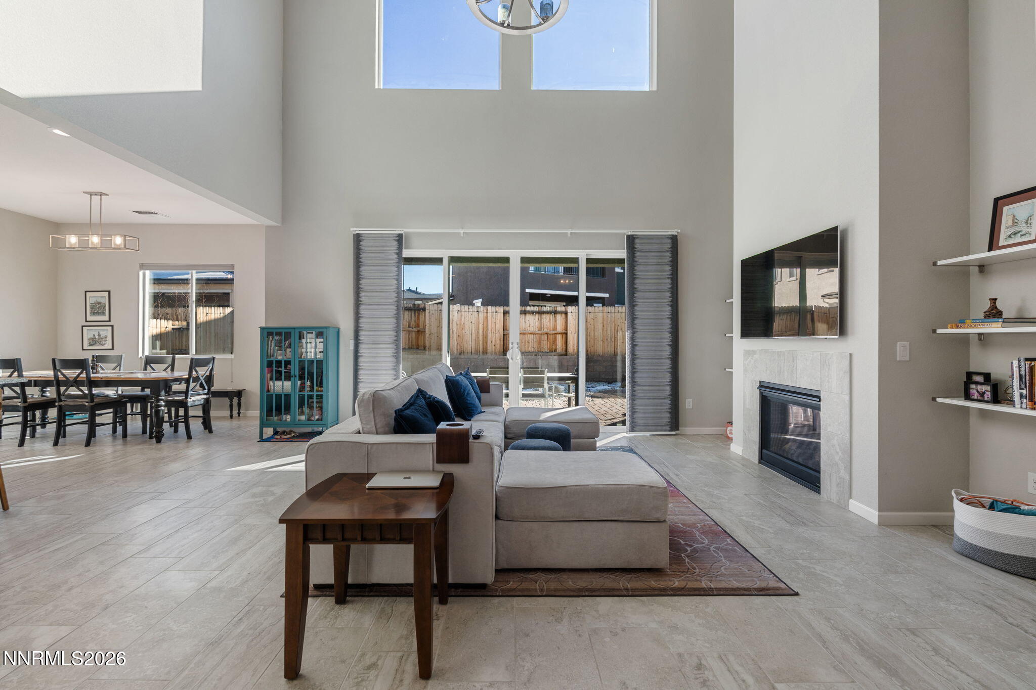 2370 Buttermere Drive Reno, NV 89521 - Photo 5 of 37 a living room with furniture a fireplace and a floor to ceiling window