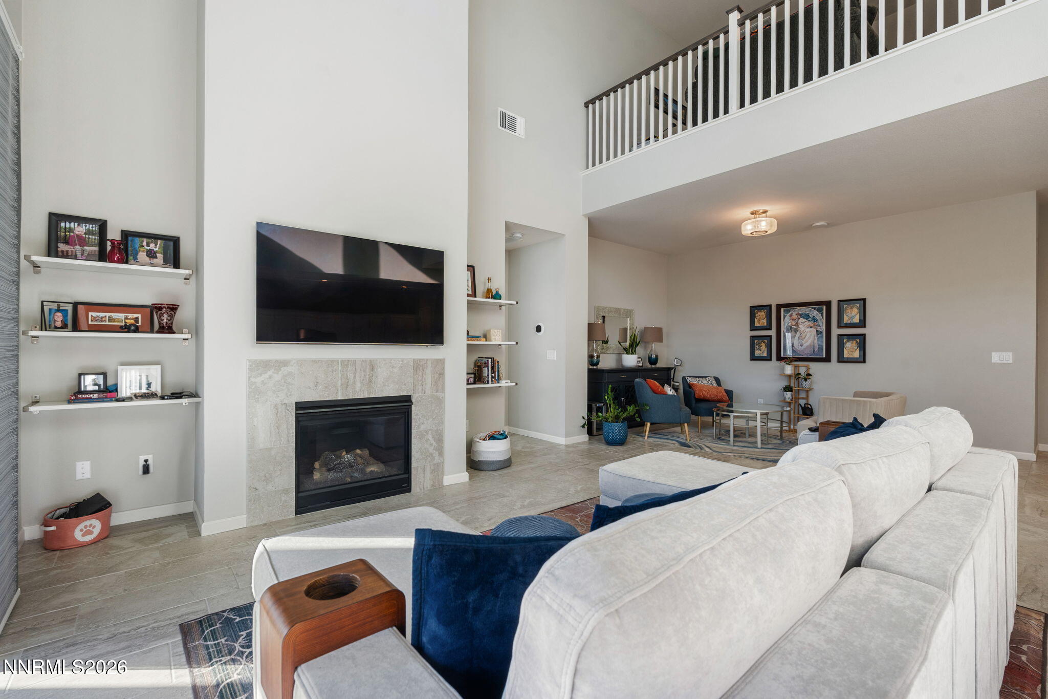 2370 Buttermere Drive Reno, NV 89521 - Photo 7 of 37 a living room with furniture a flat screen tv and a fireplace