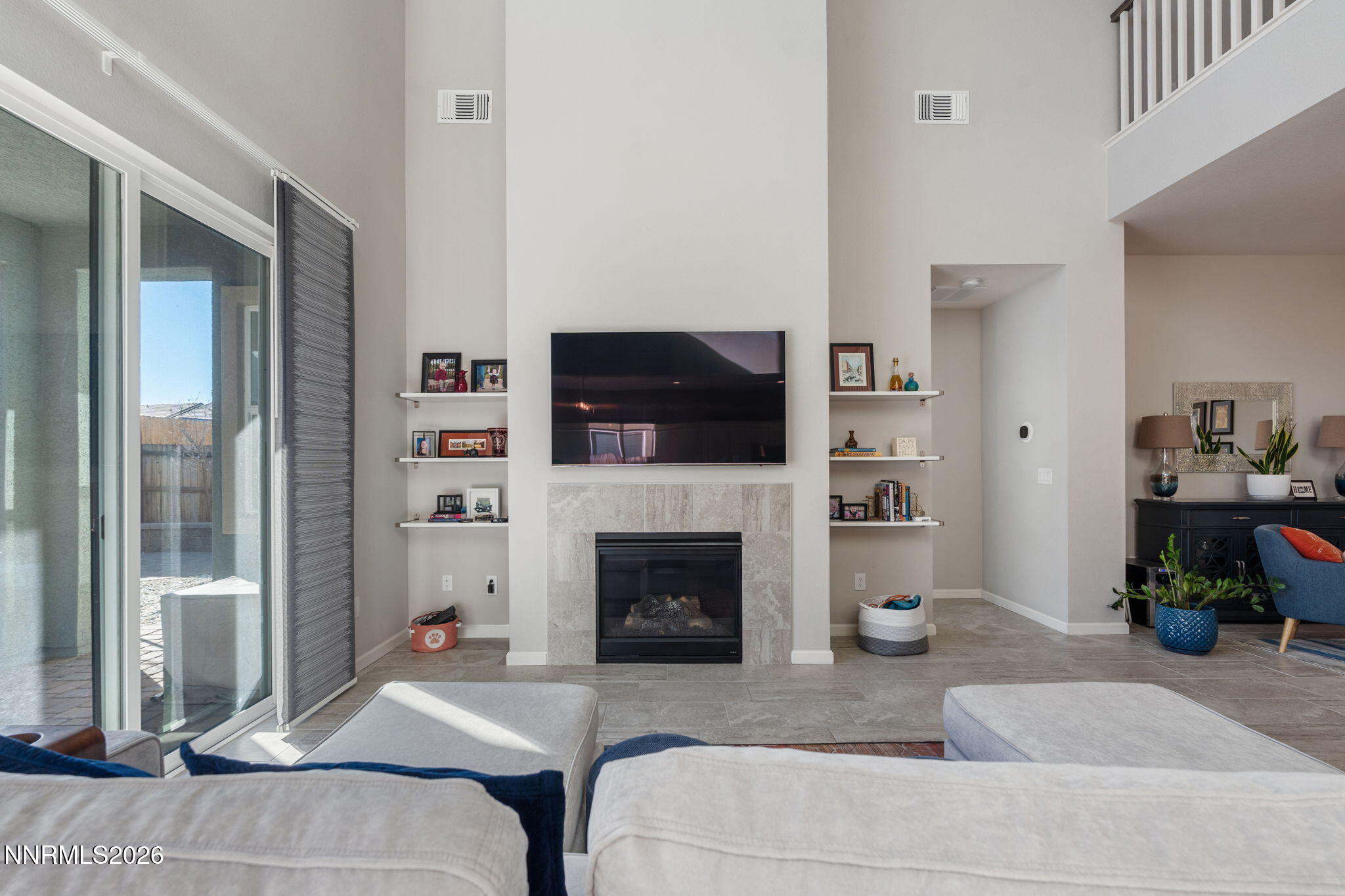 2370 Buttermere Drive Reno, NV 89521 - Photo 8 of 37 a living room with furniture a flat screen tv and a fireplace