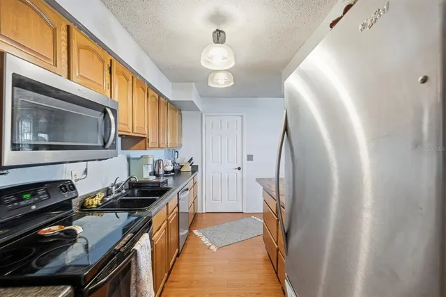 a kitchen with a sink a stove and chairs