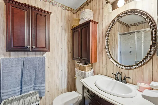 a view of a backyard with table and chairs potted plants and large tree