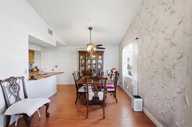a kitchen with stainless steel appliances granite countertop a sink a stove and cabinets