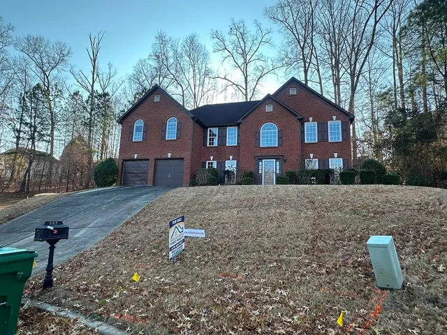 a front view of a house with a yard