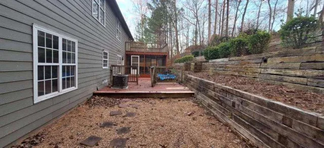 a view of a house with backyard and sitting area