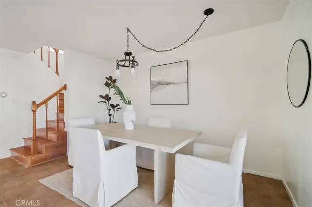 a dining room with furniture and a chandelier