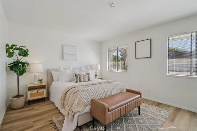 a bedroom with a bed and a potted plant