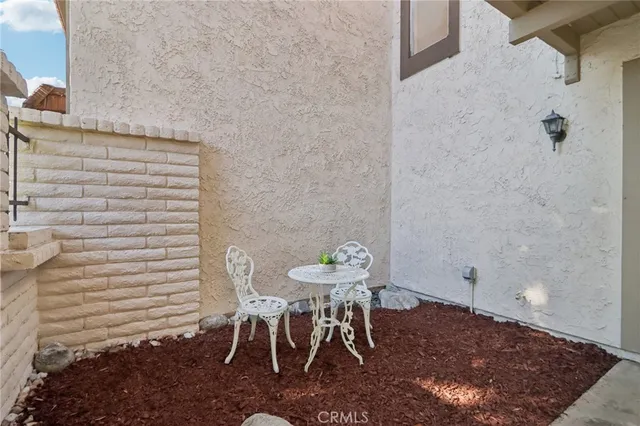 a view of a room with a table and chairs