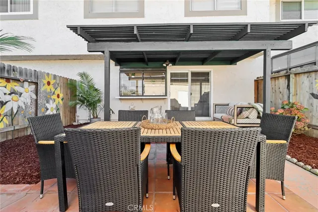 a view of a patio with table and chairs a barbeque