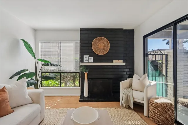 a living room with furniture a window and a fireplace