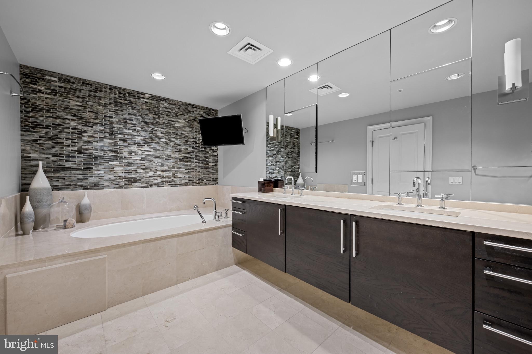 801 Key Highway, Unit 458 Baltimore, MD 21230 - Photo 25 of 48 a bathroom with a bathtub and a sink